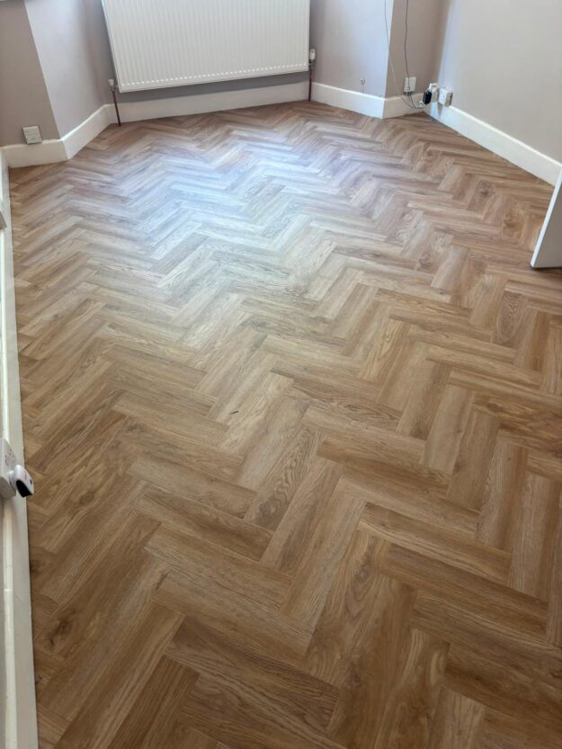 Herringbone LVT flooring installed in a Birmingham lounge